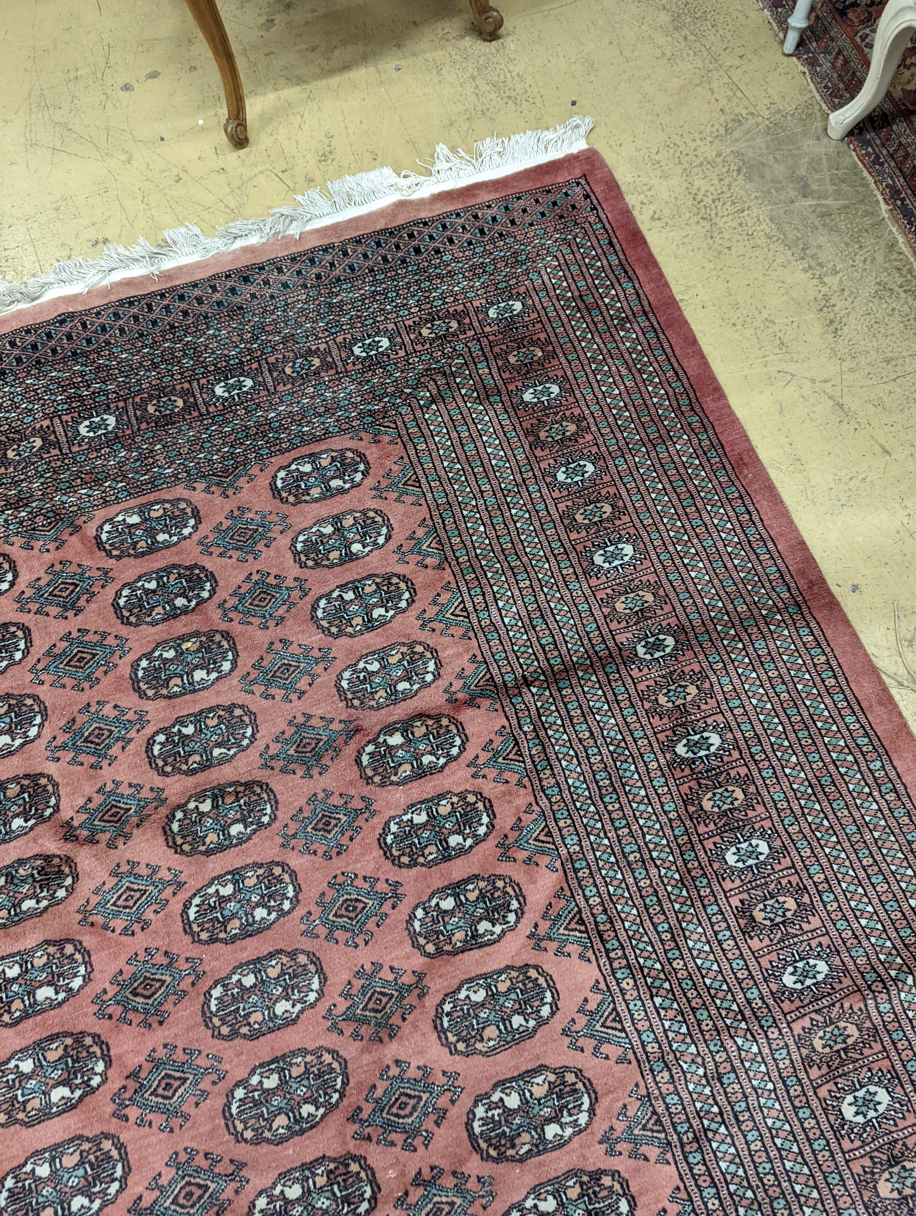 A pink ground Bokhara carpet, 315 x 220cm